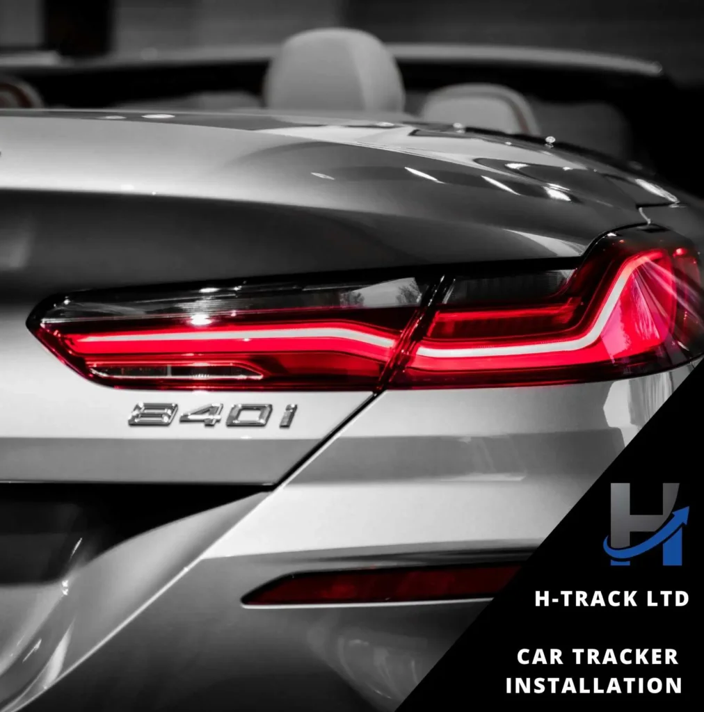Rear end of silver BMW 840i with red taillights. Car tracker installation by H-Track info