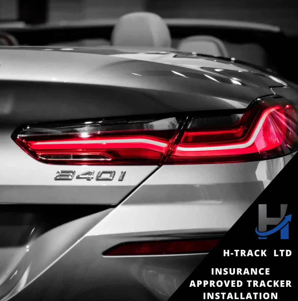 Rear end of silver BMW 840i with red taillights. Insurance Approved tracker installation by H-Track info
