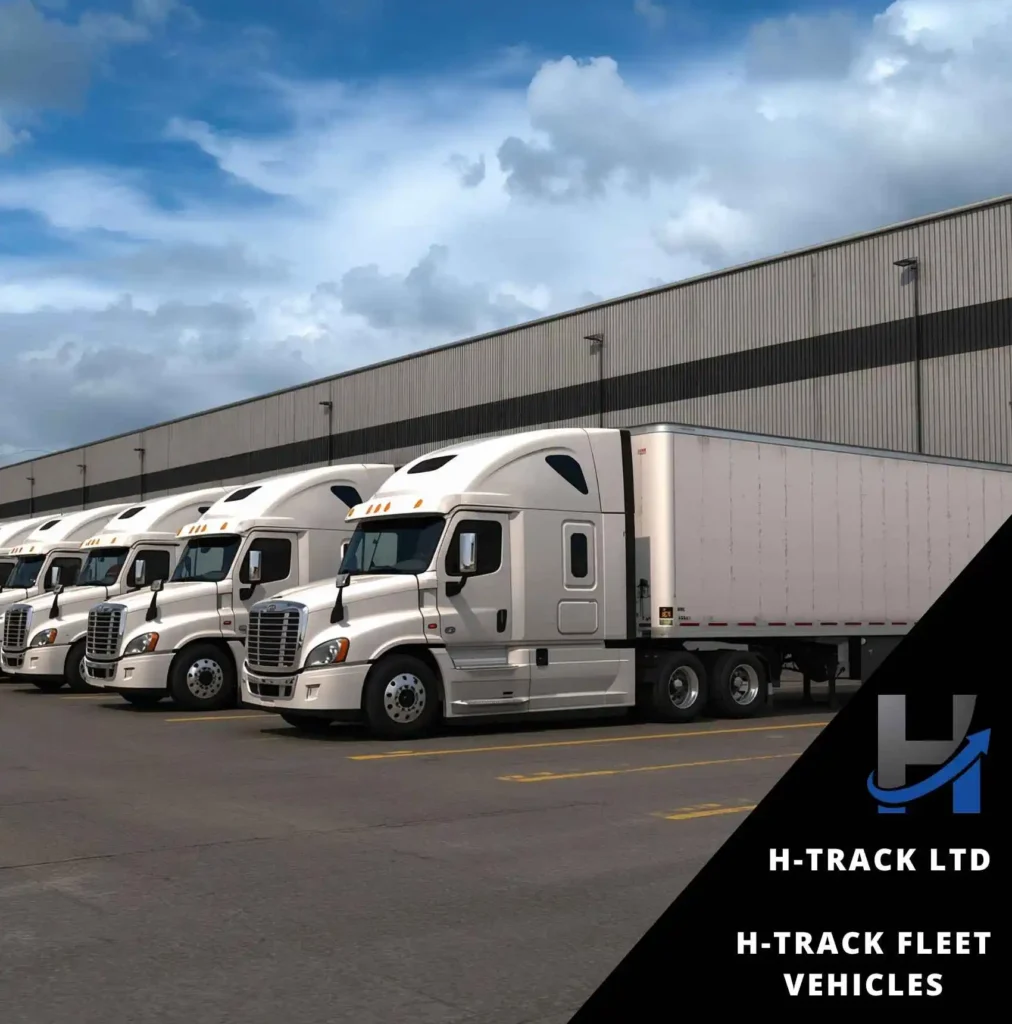 A row of white articulated trucks in front of a warehouse with H-Track Fleet Vehicles management