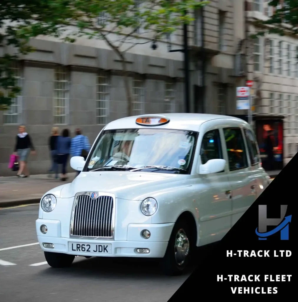 White taxi on a UK road as part of a fleet under H-Track Fleet vehicles management