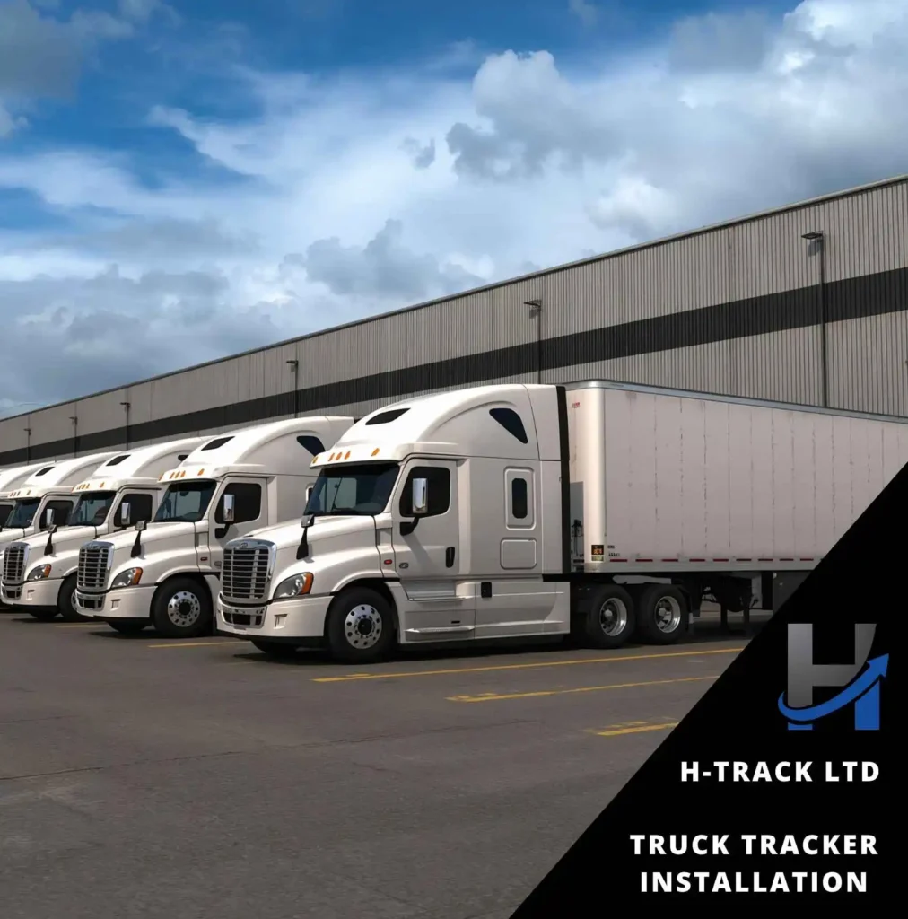 Row of white articulated trucks lined up against a warehoue each with a H-Track Fleet vehicle truck tracker installation