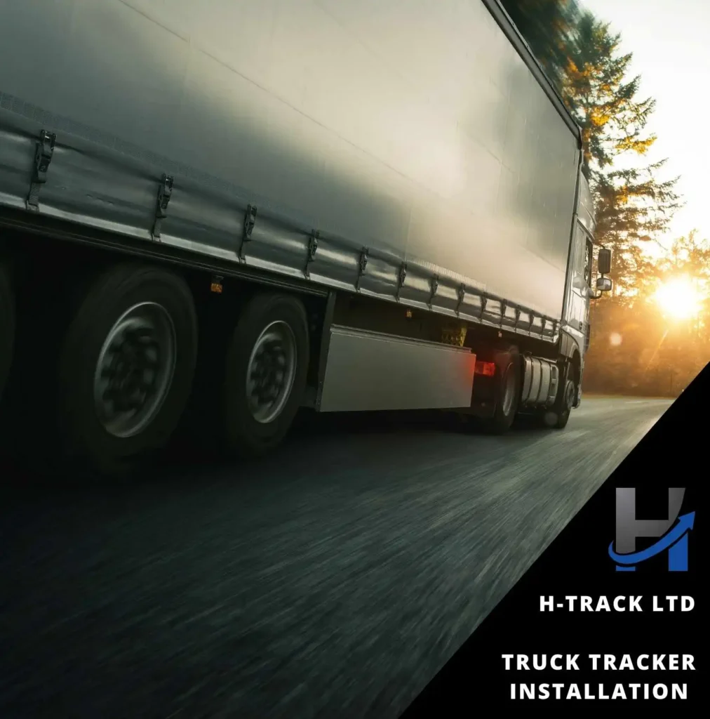 A white truck with articulated container and Truck tracker installation driving on a tarmac road towards a setting sun