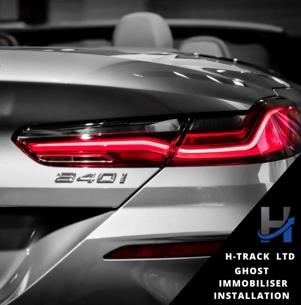 Rear end of silver BMW 840i with red taillights. Ghost Immobiliser installation by H-Track info