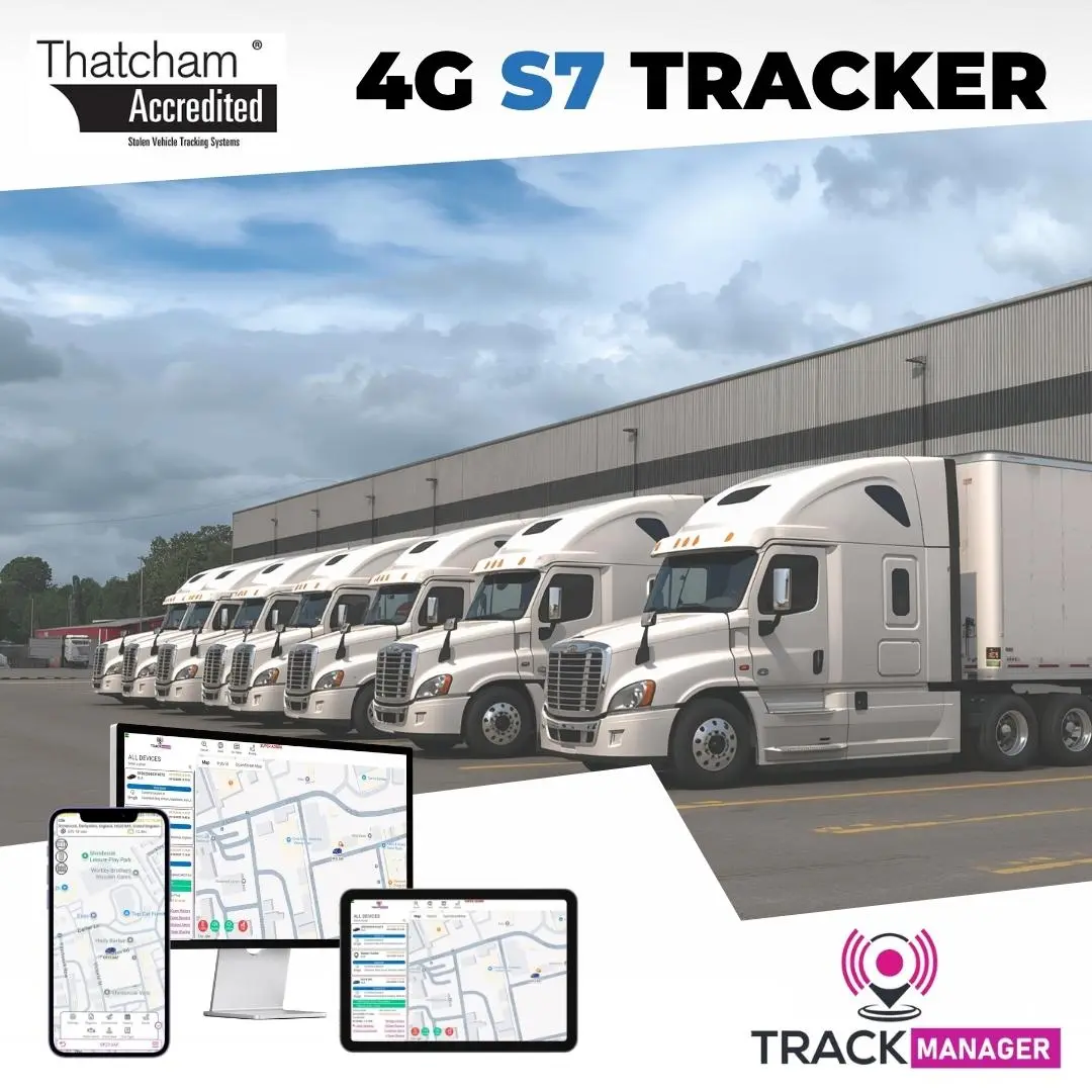 Row of White articulated lorries parked in front of grey warehouse highlighting Thatcham Approved S7 Tracker and immobiliser bundle by H-Track Ltd